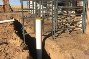 Professional Drinking Post waterer installation showing underground plumbing and leach field