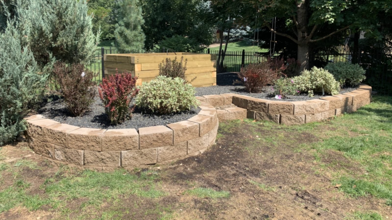 Finished retaining-wall planter beds and lawn installed by Idaho Sprinkler Repair