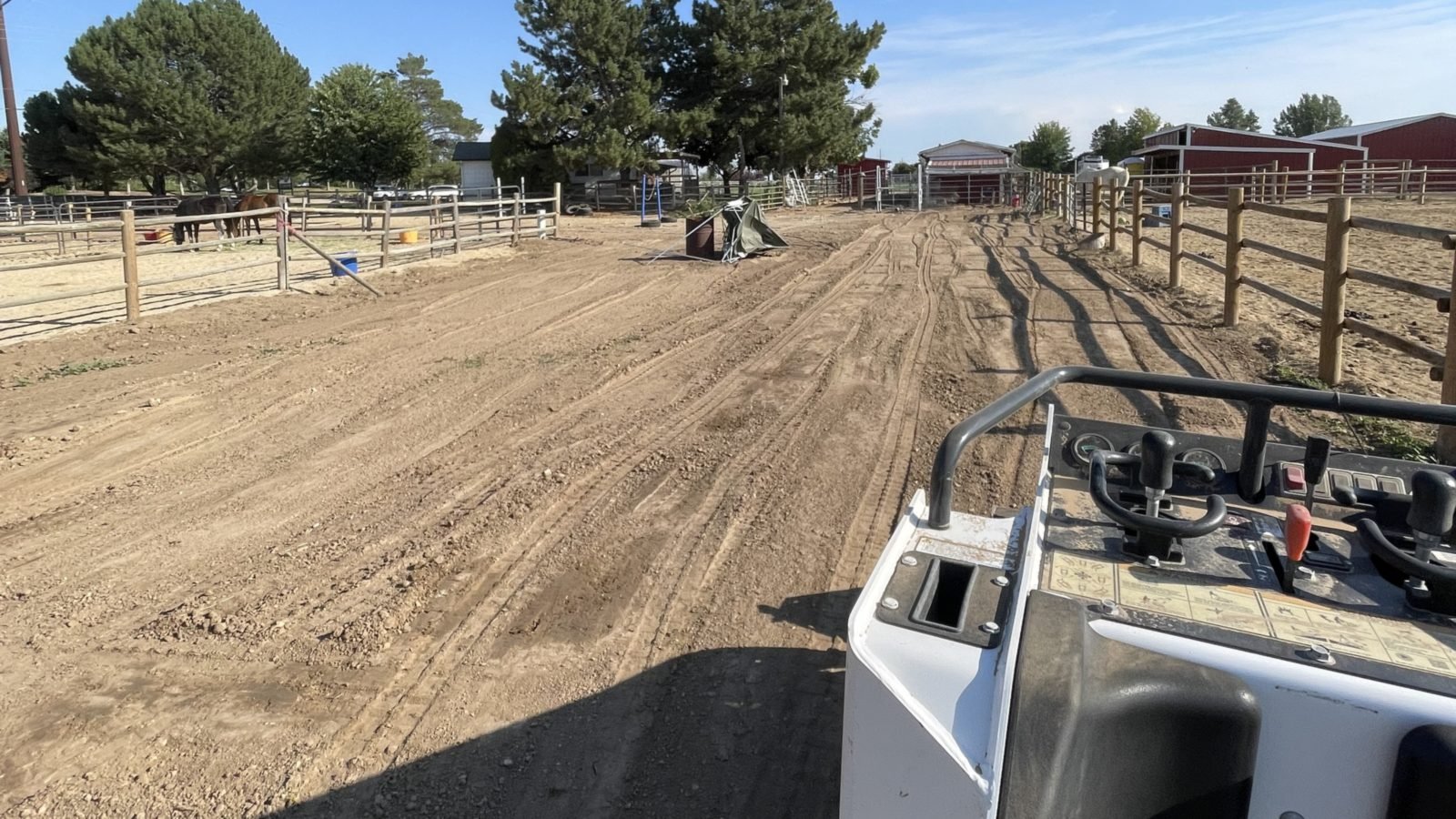 Skid steer on a Treasure Valley horse property during a Drinking Post waterer installation